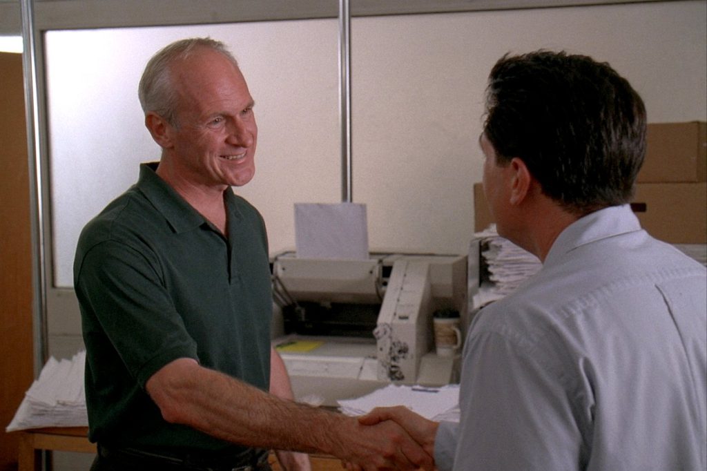 A Mantronics representative shaking hands with a customer in a mailroom